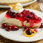 Cranberry orange cheesecake served on a plate.