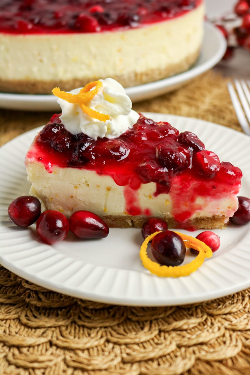 Cranberry orange cheesecake served on a plate.