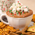 Hot chocolate dip in bowl with mini marshmallow garnish.