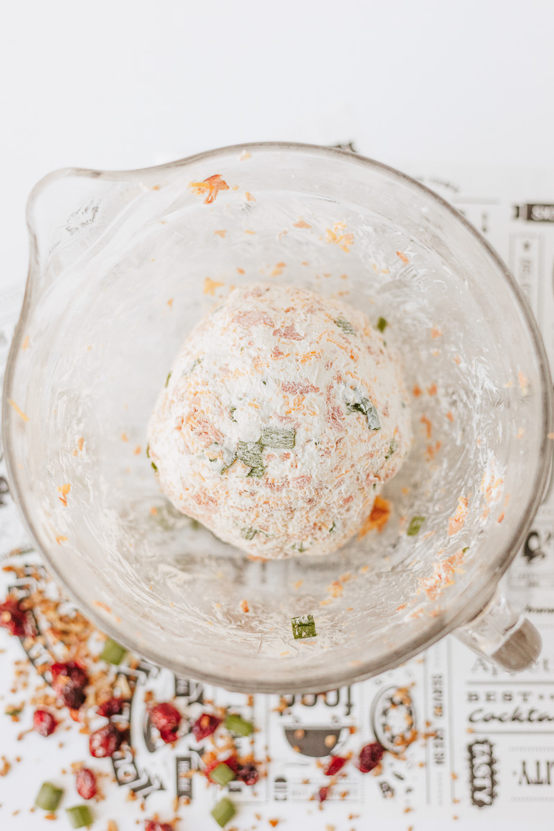 Cheeseball ingredients are mixed together into a large ball.