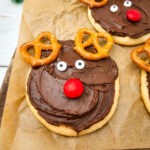 Reindeer sugar cookies on wooden board.