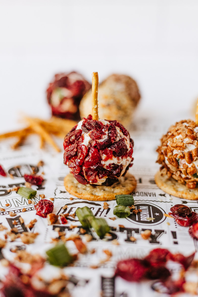 A pretzel stick is added to the mini cheeseball.