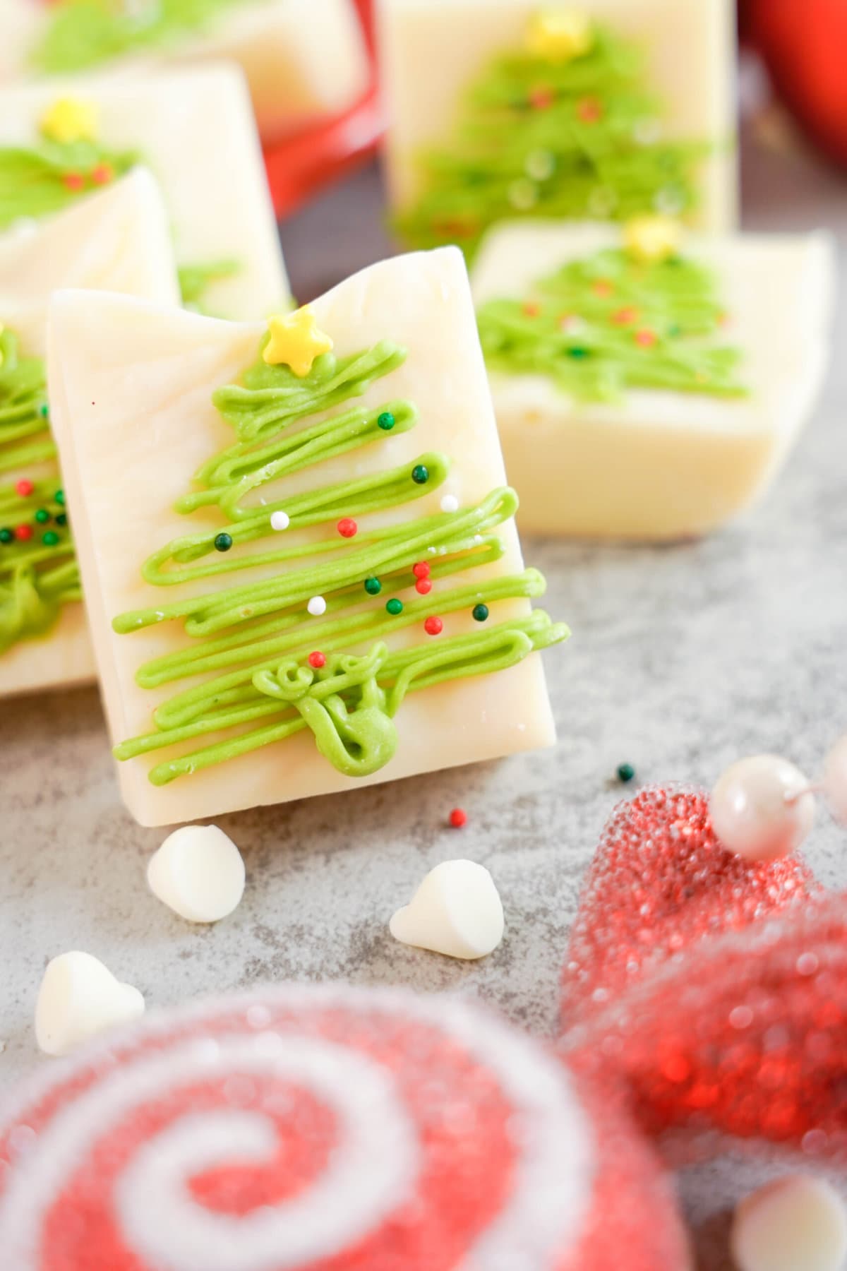 Christmas tree fudge stacked on a plate.