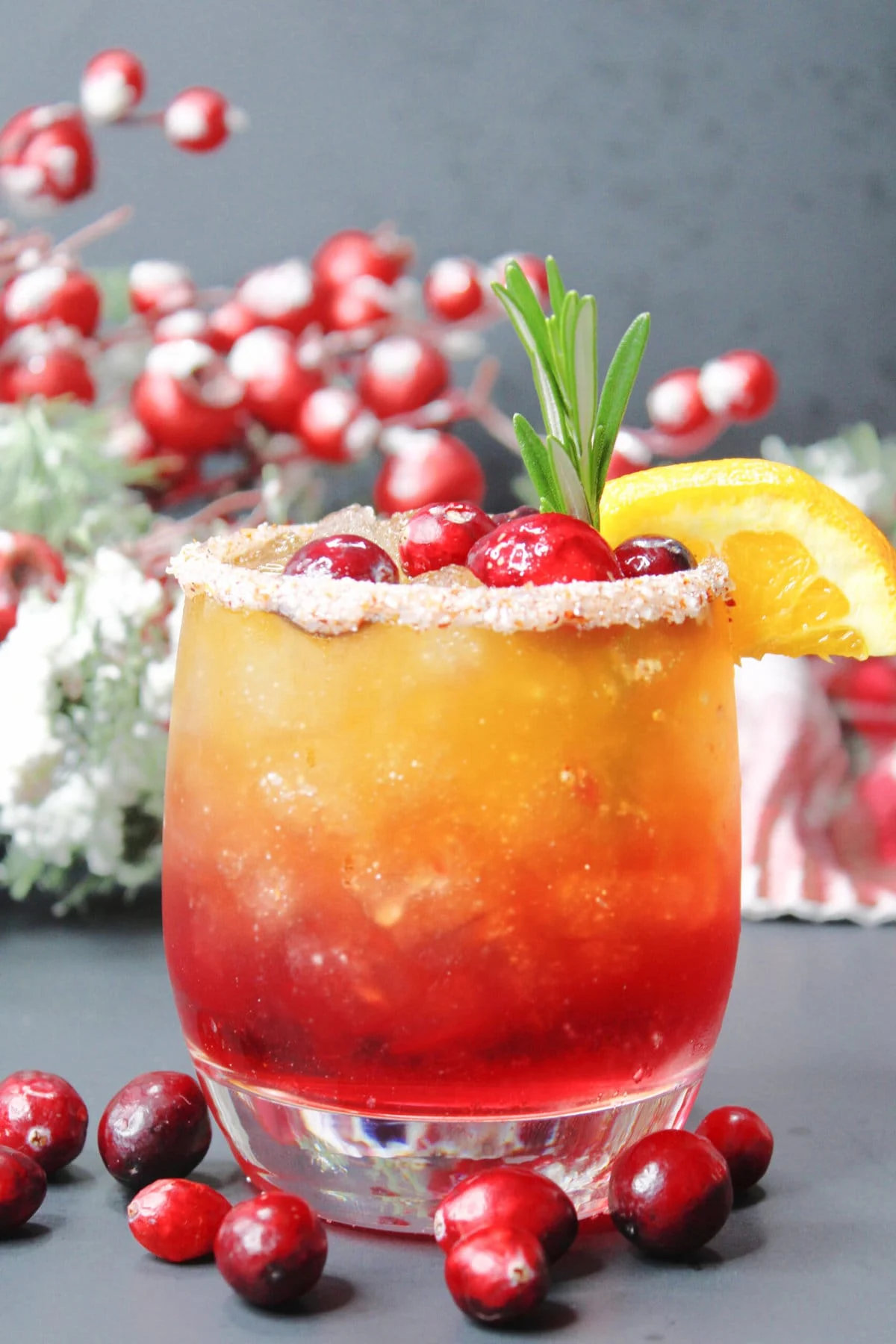 Naughty and nice cocktail in glass with cranberries on the side.