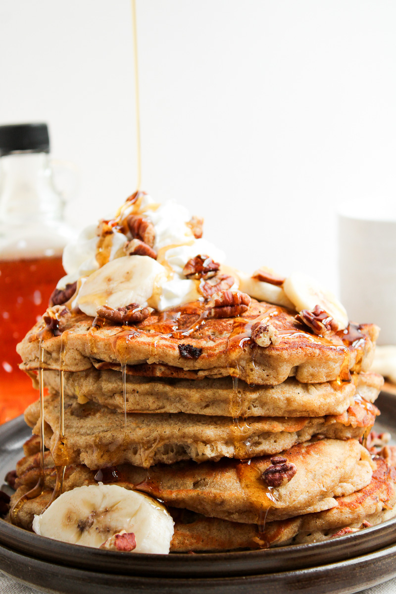 Drizzle of syrup over pancakes on plate.