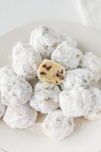 Chocolate chip snowball cookies on a plate.