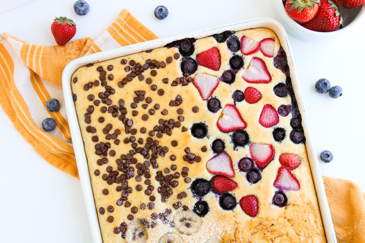 Baked pancakes with toppings on sheet pan ready to cut and serve.