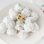Chocolate chip snowball cookies on a plate.