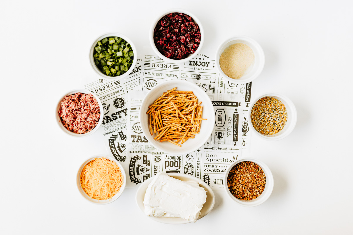 Ingredients for cheese ball bites laid out on counter in small bowls; prepared for the recipe.