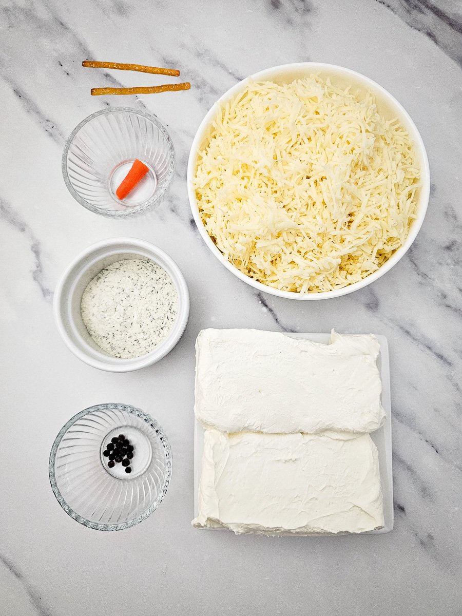 Snowman cheseball ingredients together on counter in preparation for the recipe.
