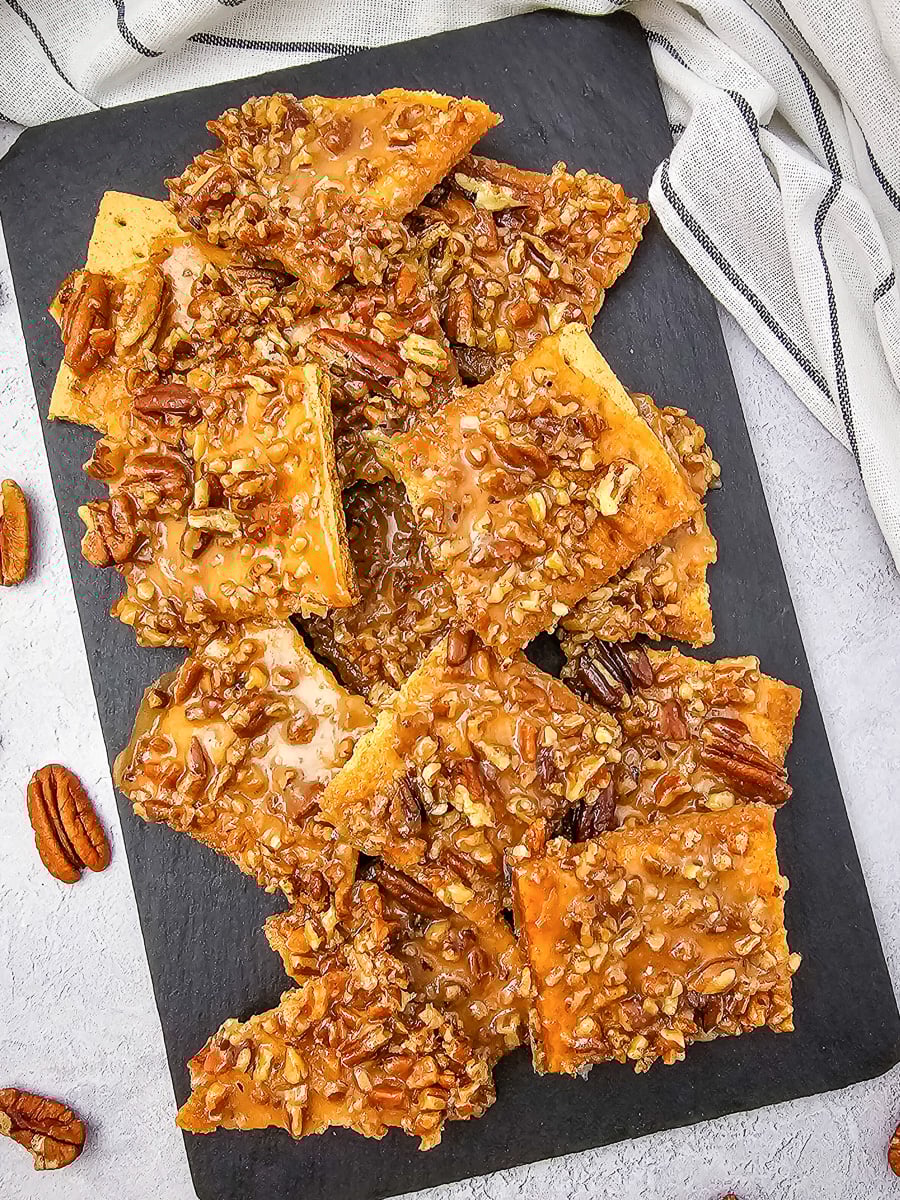 Pecan pie bark on wooen board.