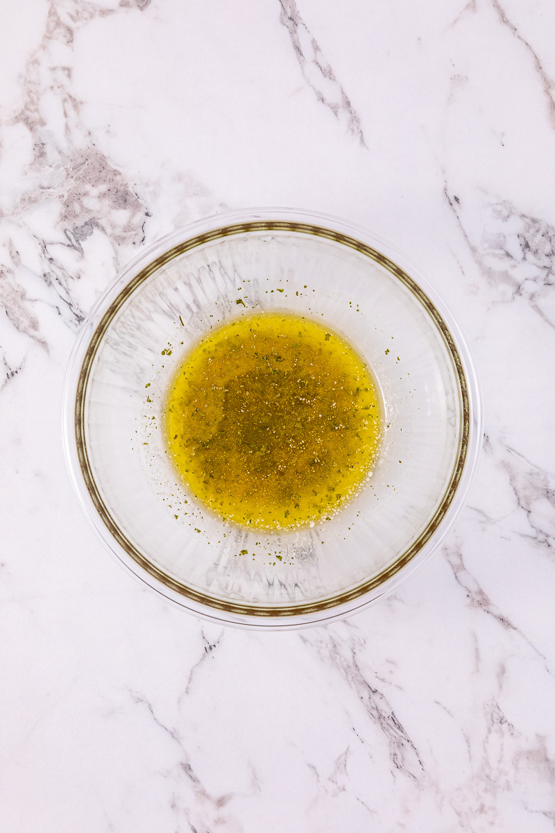 Butter and parsley mixture in small glass bowl.