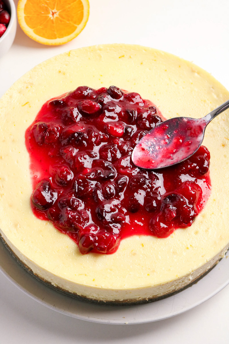 Filling is spread on top of the cheesecake.