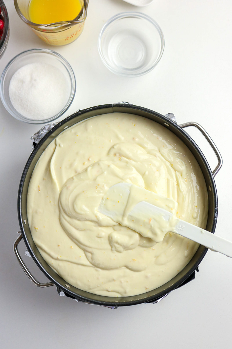 Fillign is spread evenly into springform pan.