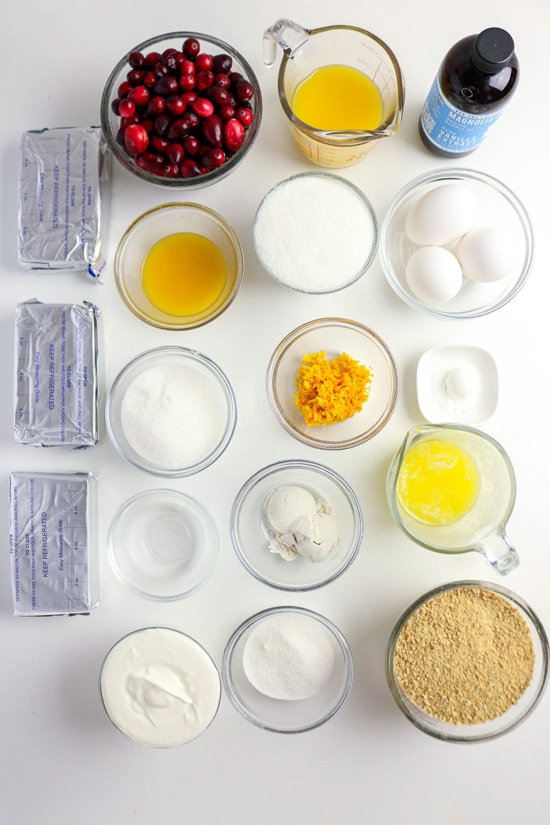 Ingredients for cranberry orange cheesecake prepped in small bowls on counter.