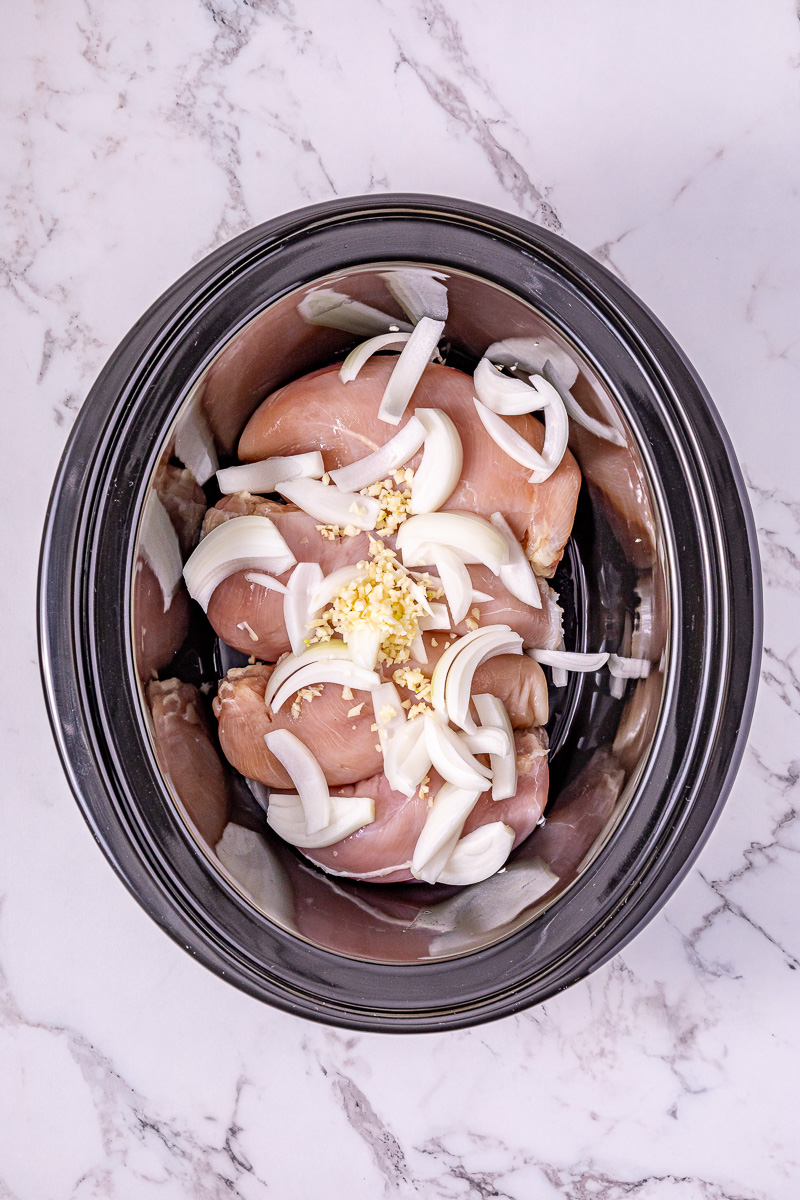 Chicken and onions in crockpot.