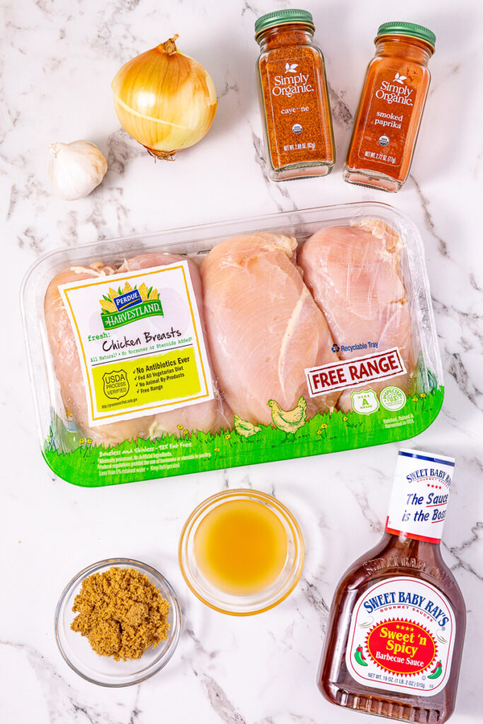 Ingredients for crockpot pulled bbq chicken laid out on counter in preparation for the recipe.