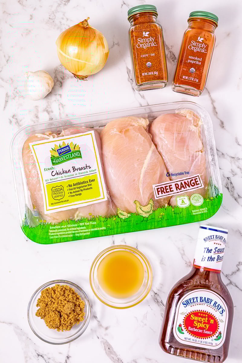 Ingredients for crockpot pulled bbq chicken laid out on counter in preparation for the recipe.