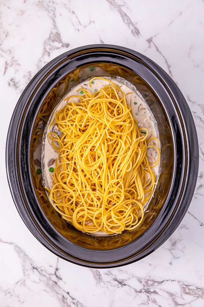 Cooked spaghetti noodles are added in and stirred into the turkey mixture.