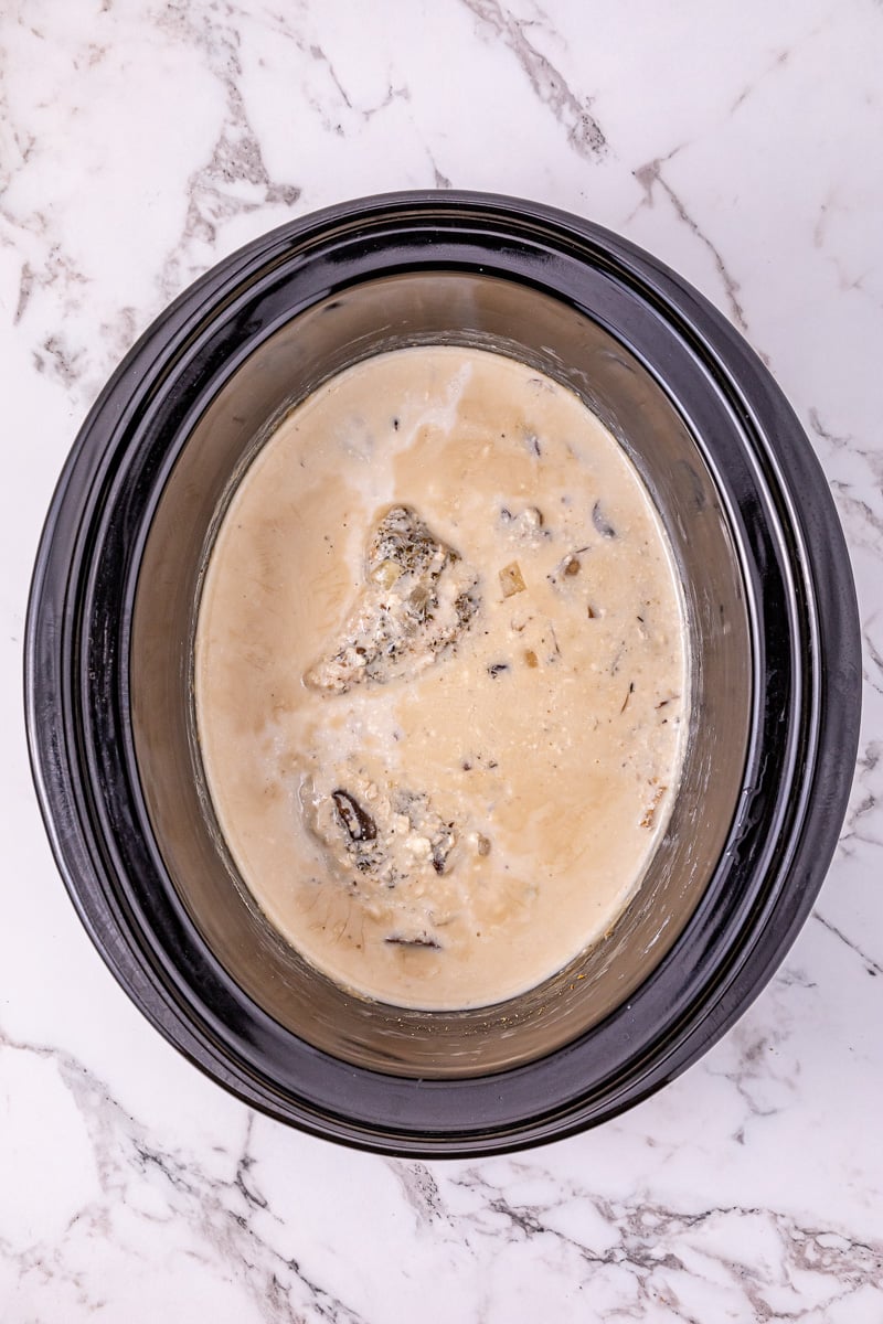 Cream of mushroom soup is added to the top of the mixture.