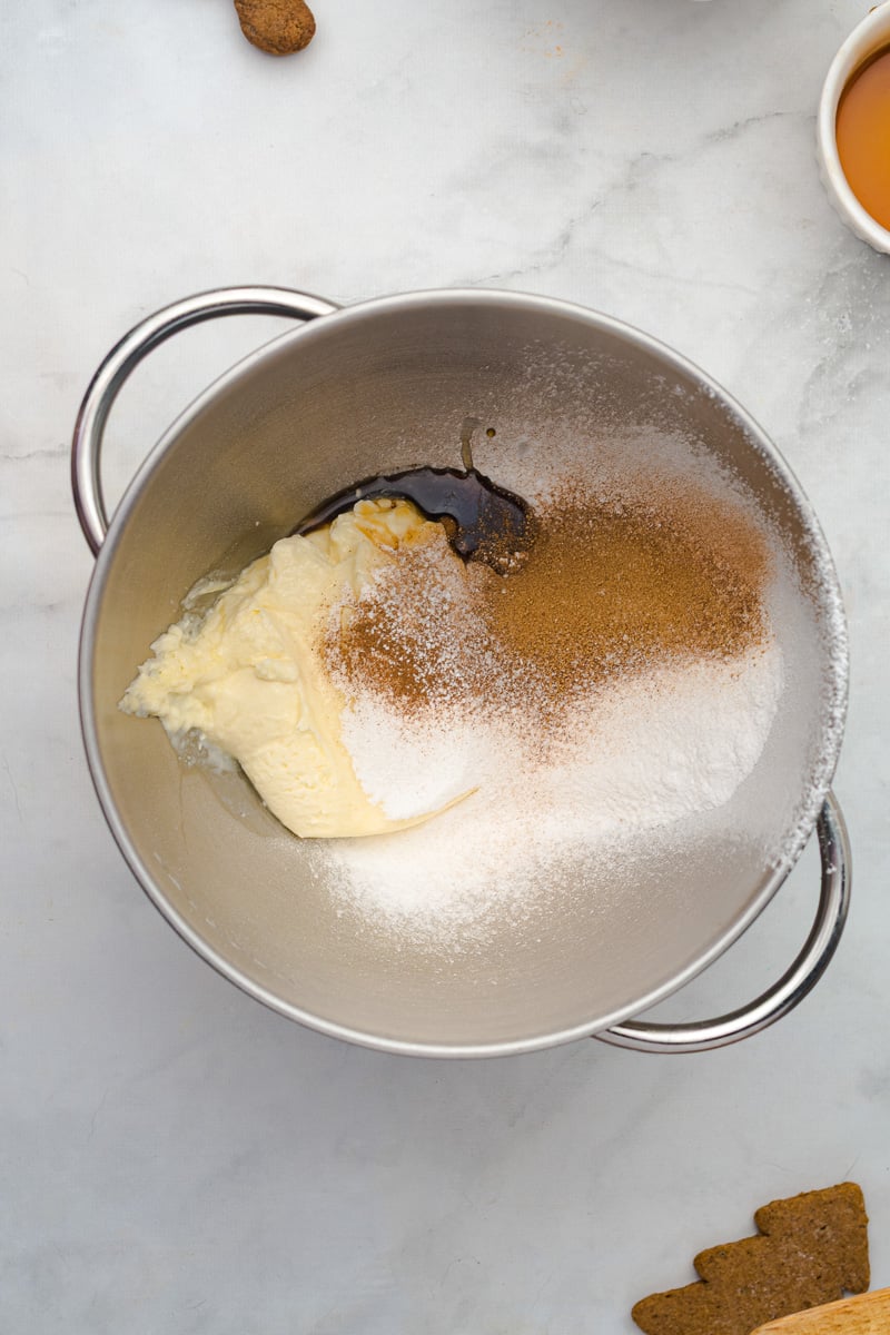Cream cheese and spices in mixing bowl with sugar.
