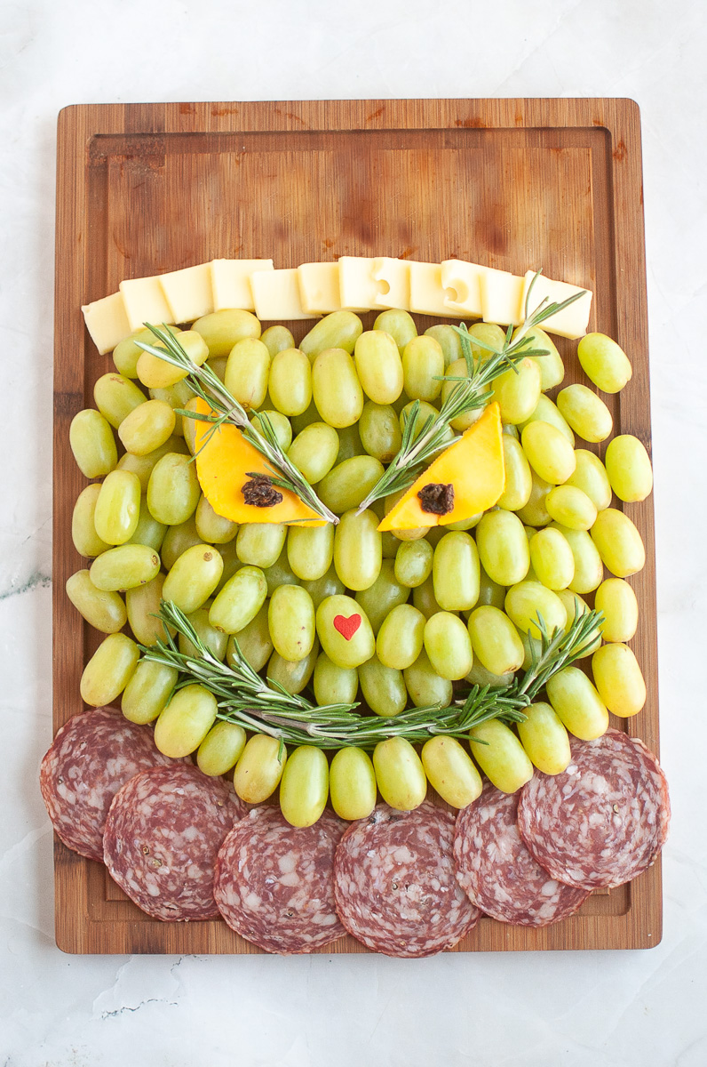 Cheese rectangles are placed above the Grinch forehead.