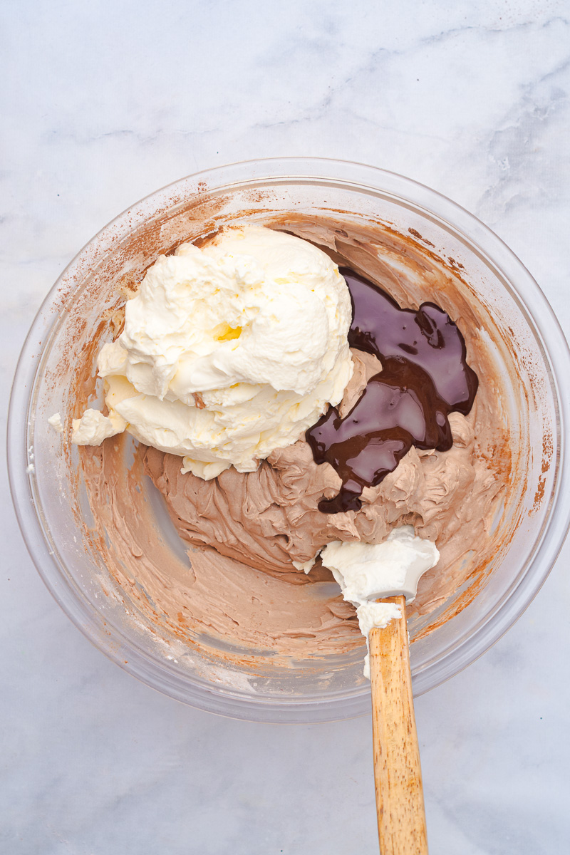 Melted dark chocolate is added to the bowl.
