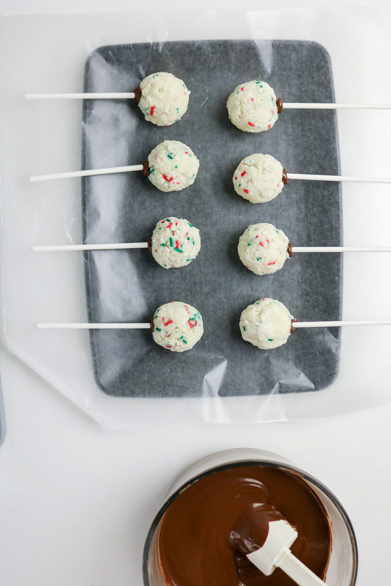 Cake balls with lollipop stick pressed into them.