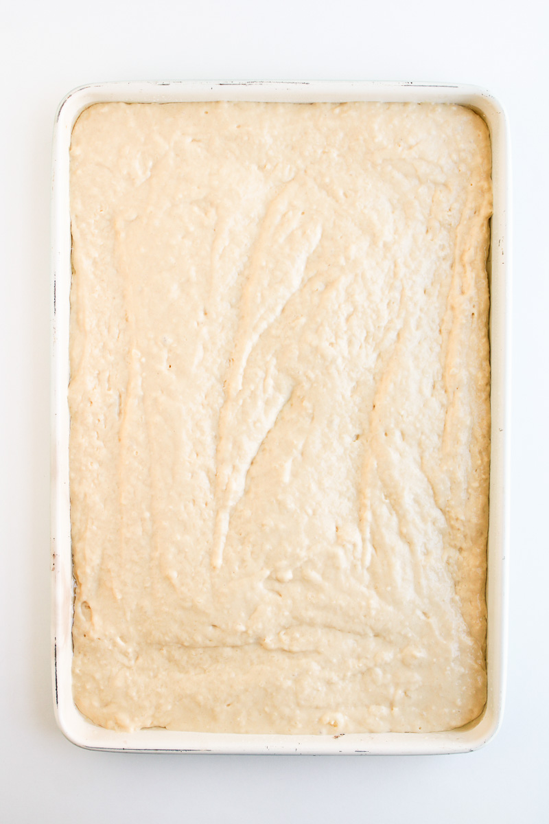 Pancake batter is sptread out evenly on baking sheet.