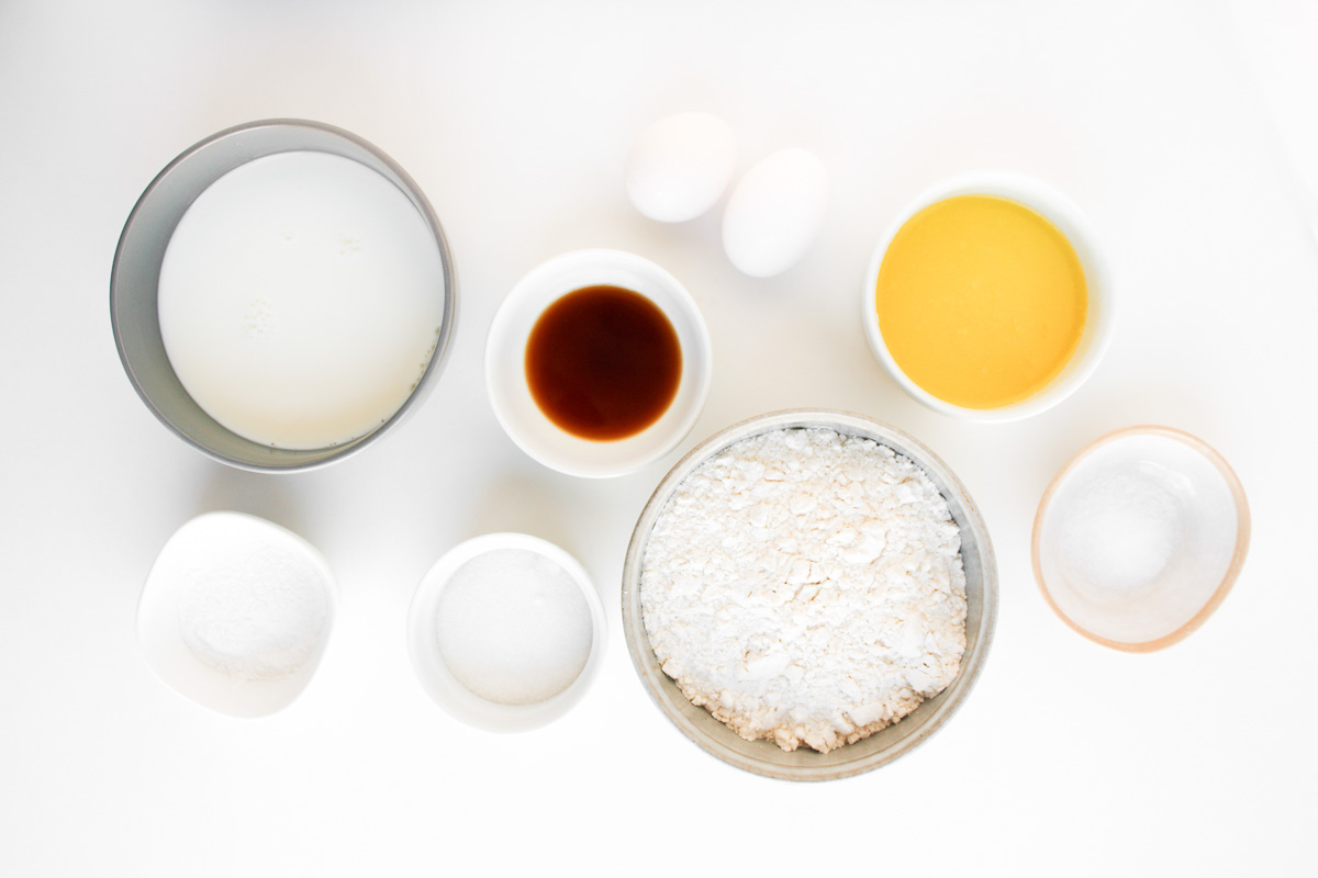 Ingredients for sheet pan pancakes in small bowls on counter.