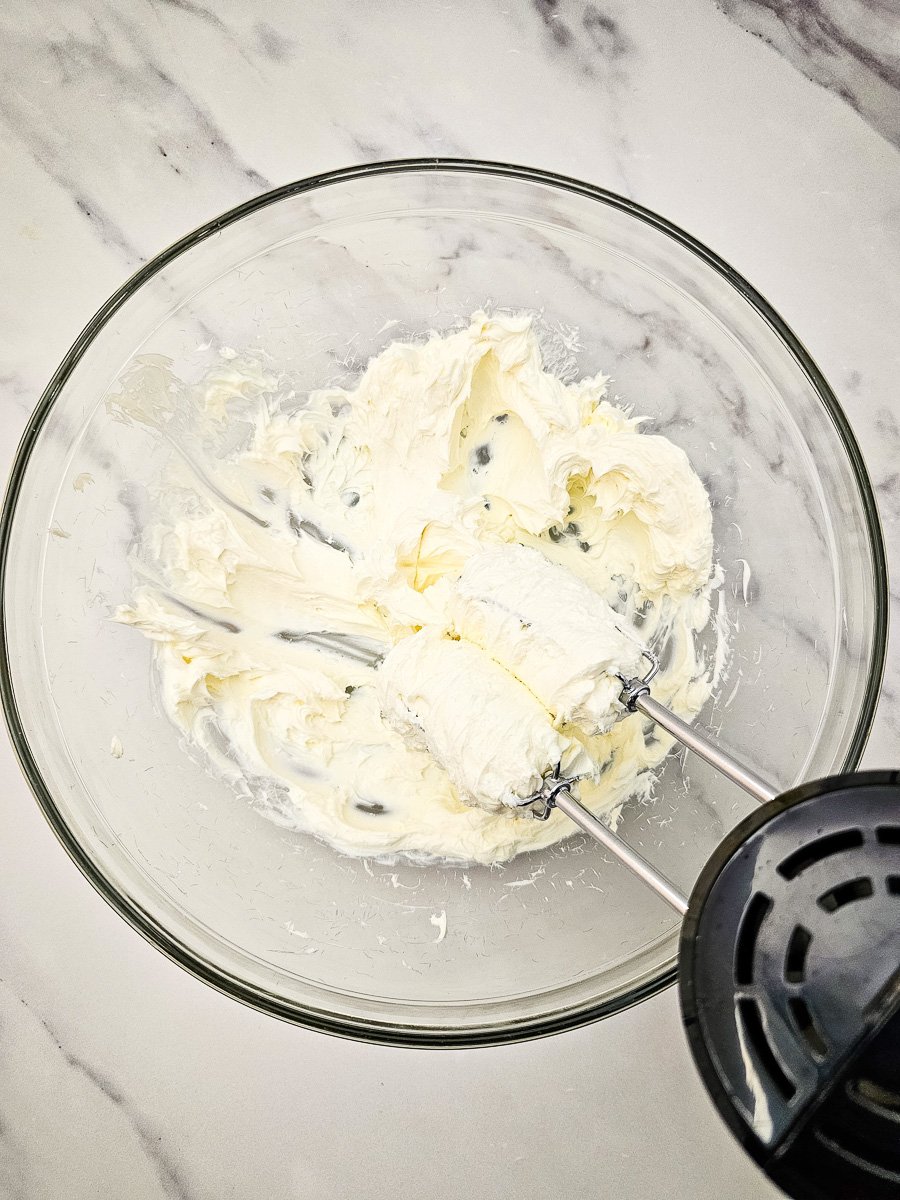 Cream cheese in mixing bowl with ranch seasoning.
