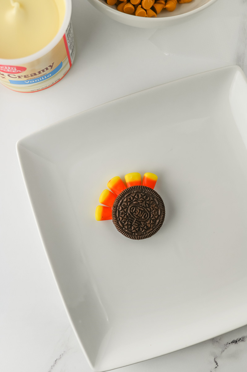 Candy corn is wedged into the Oreo cookie.
