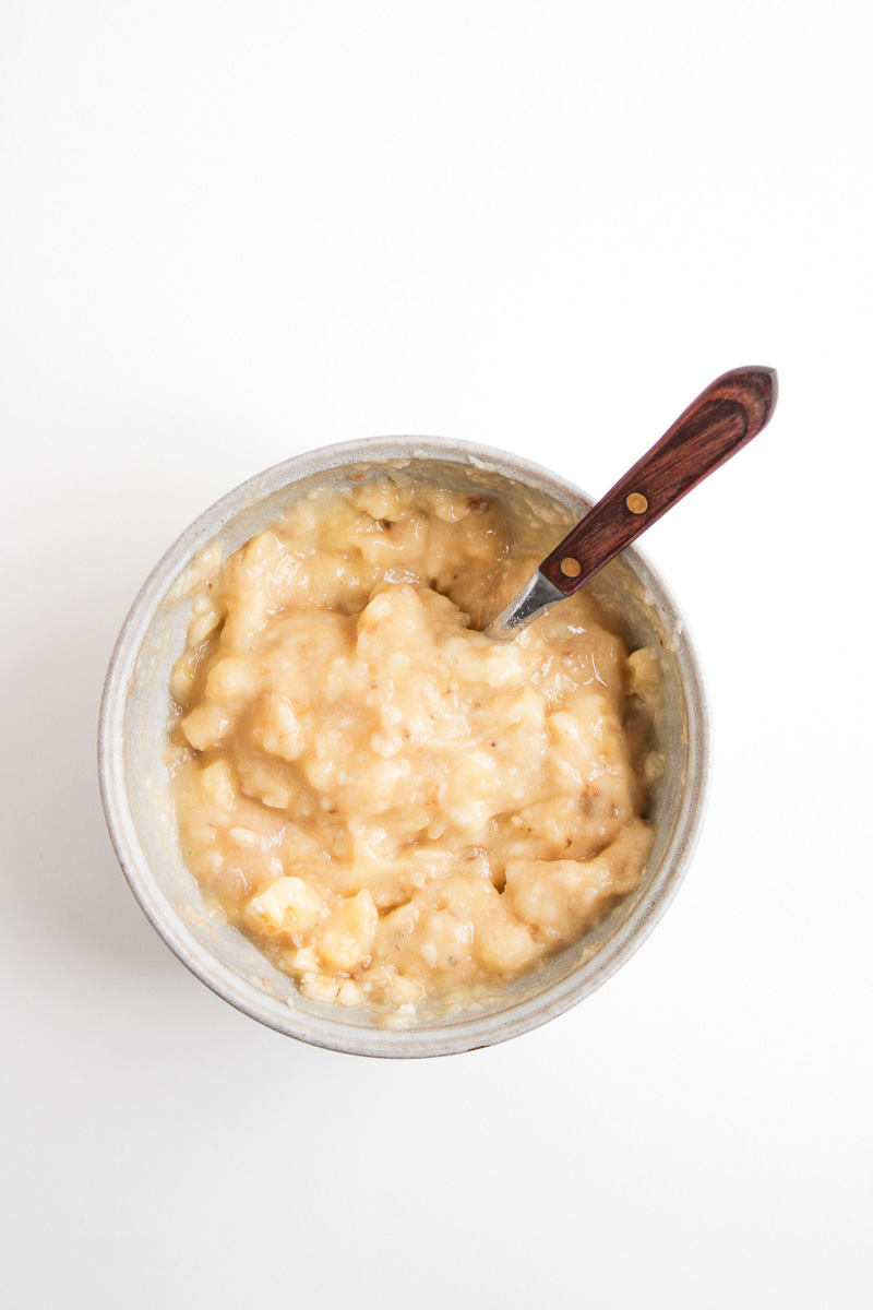 Mashed bananas in a small bowl.