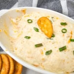 Hot seafood dip in white dish.