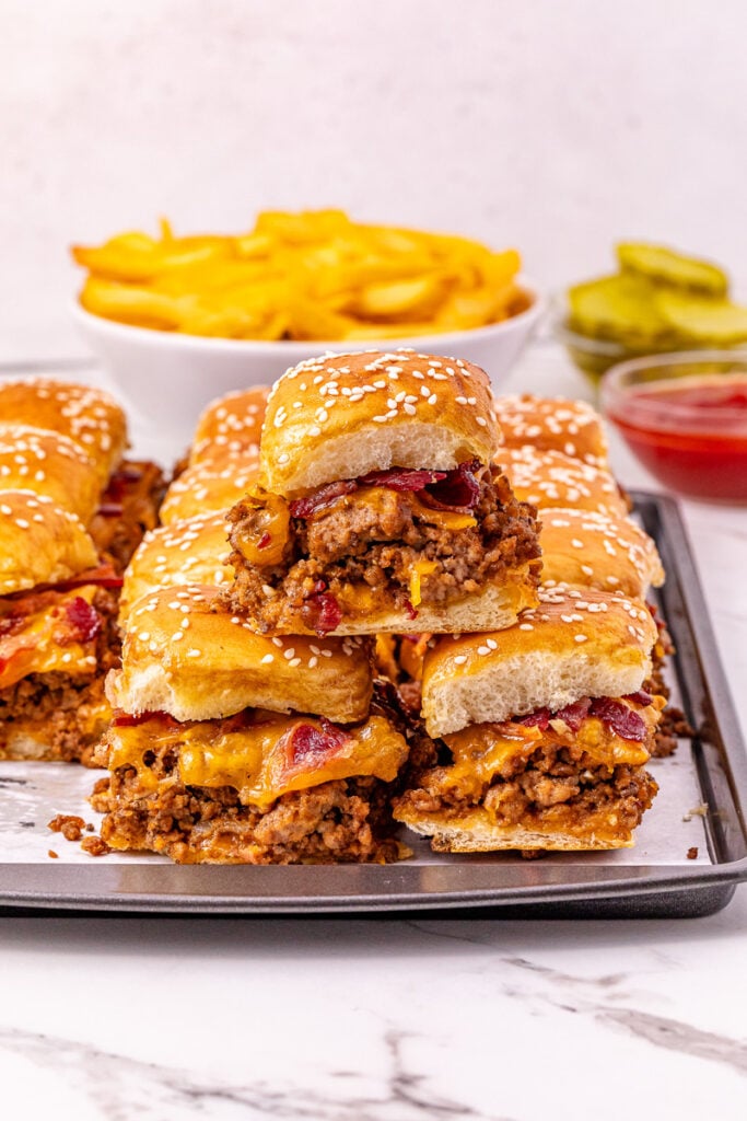 Finished dish of bacon cheeseburger sliders on plate.