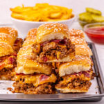 Bacon cheeseburger sliders on a plate.