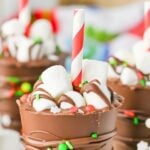 Hot chocolate on a stick in a group on counter.