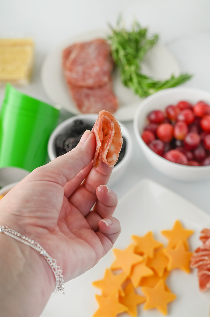 Salama is folded then poked through a skewer.