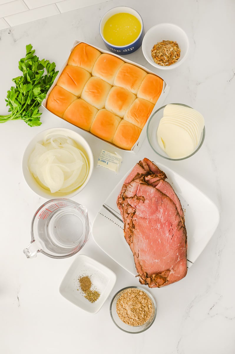 Ingredients for French dip sliders placed on counter in preparation for the recipe.