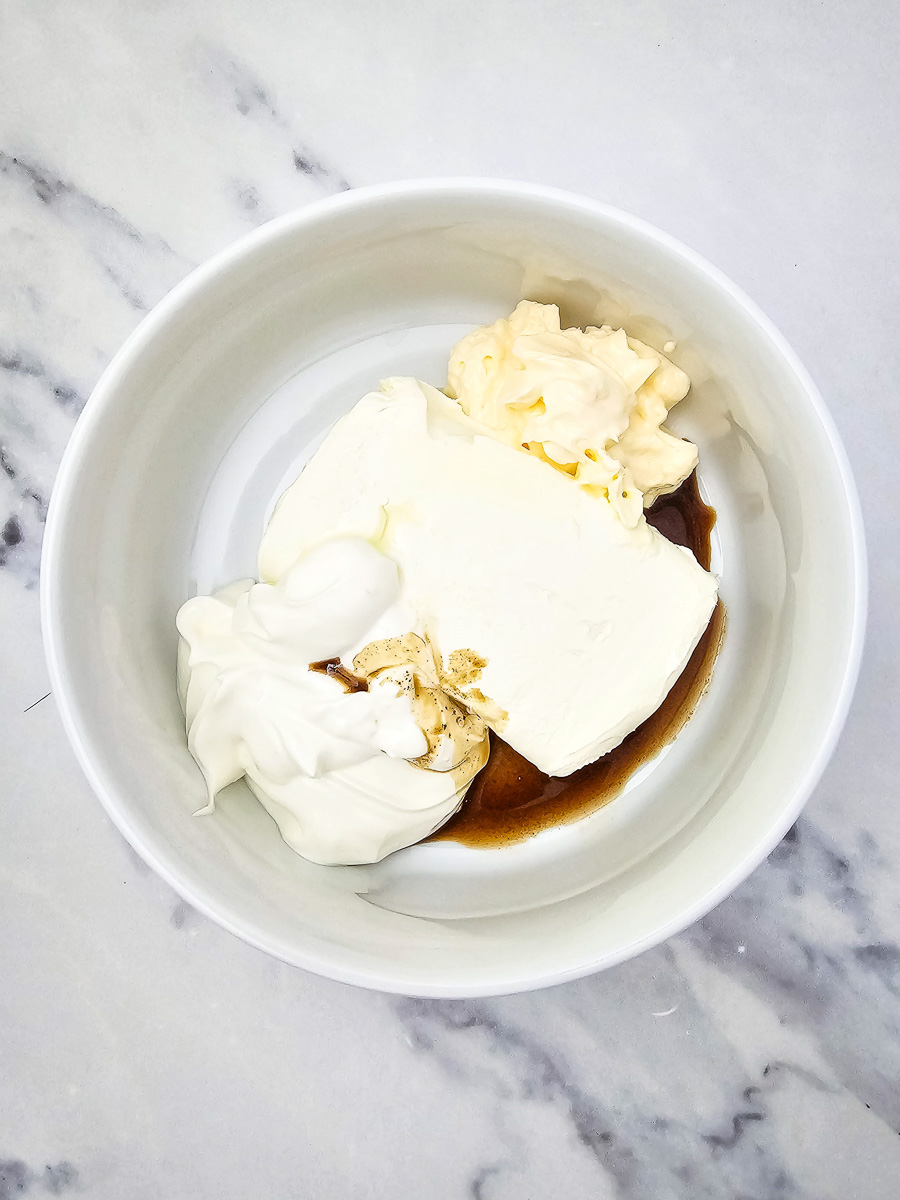 Cream cheese, sour cream, mayonnaise, worcestershire sauce, lemon juice, and garlic powder in glass mixing bowl.