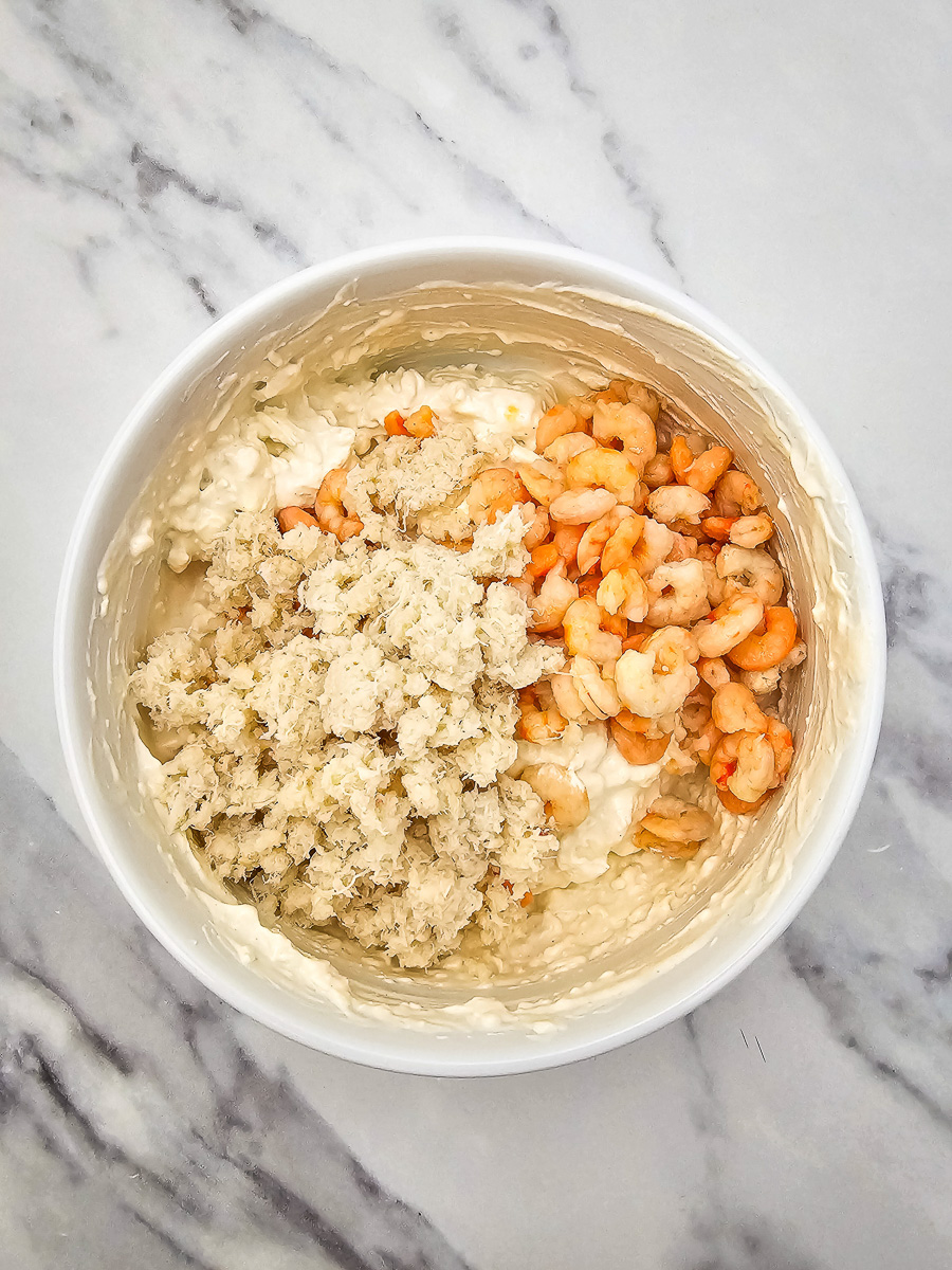 Crab and shrimp are added to the cream cheese mixture.