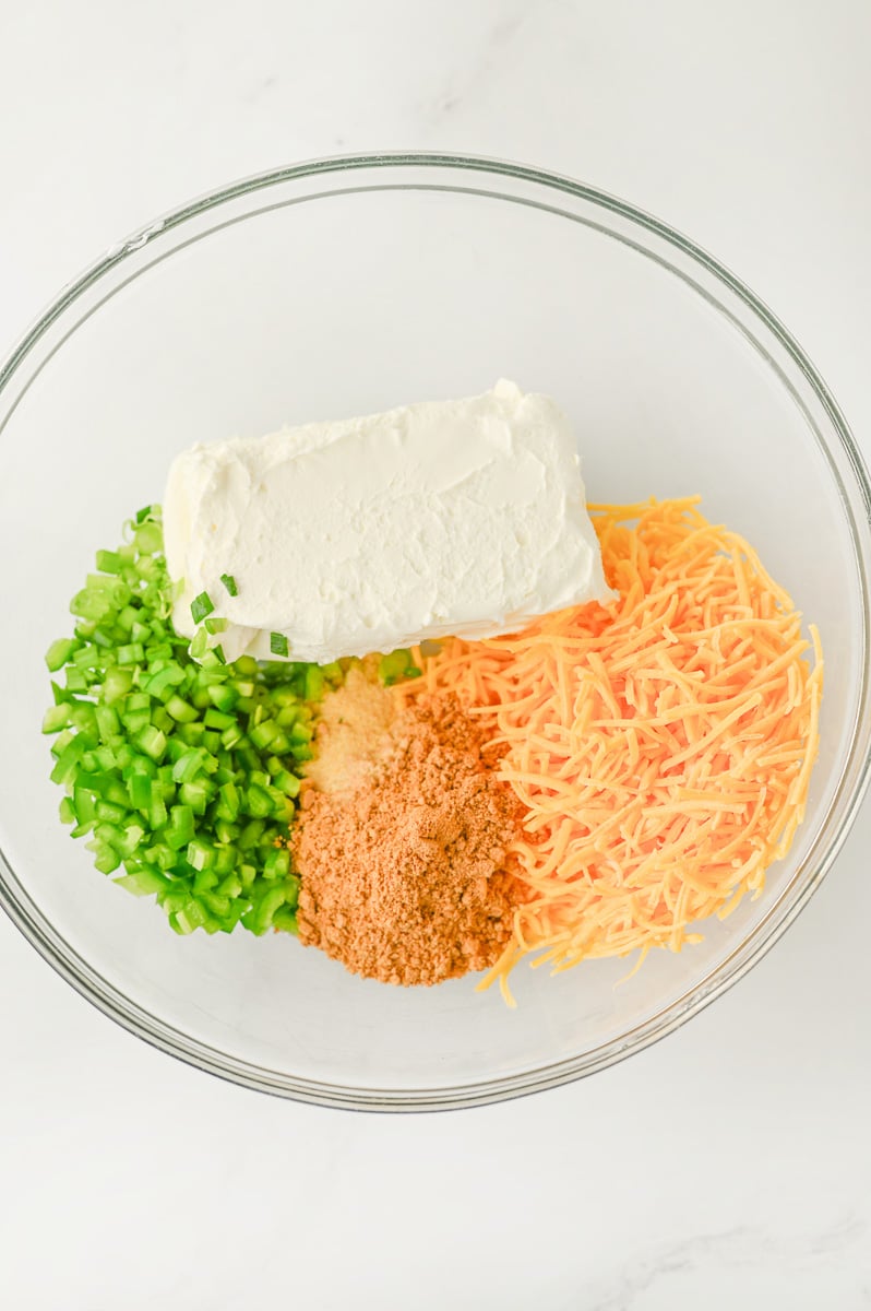 Ingredients to cheese ball filling in glass bowl.