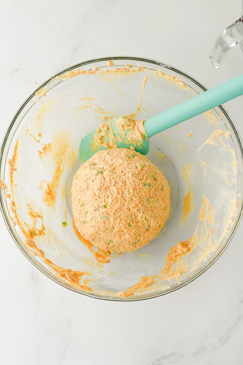 Cheese ball mixture is shaped into a ball.