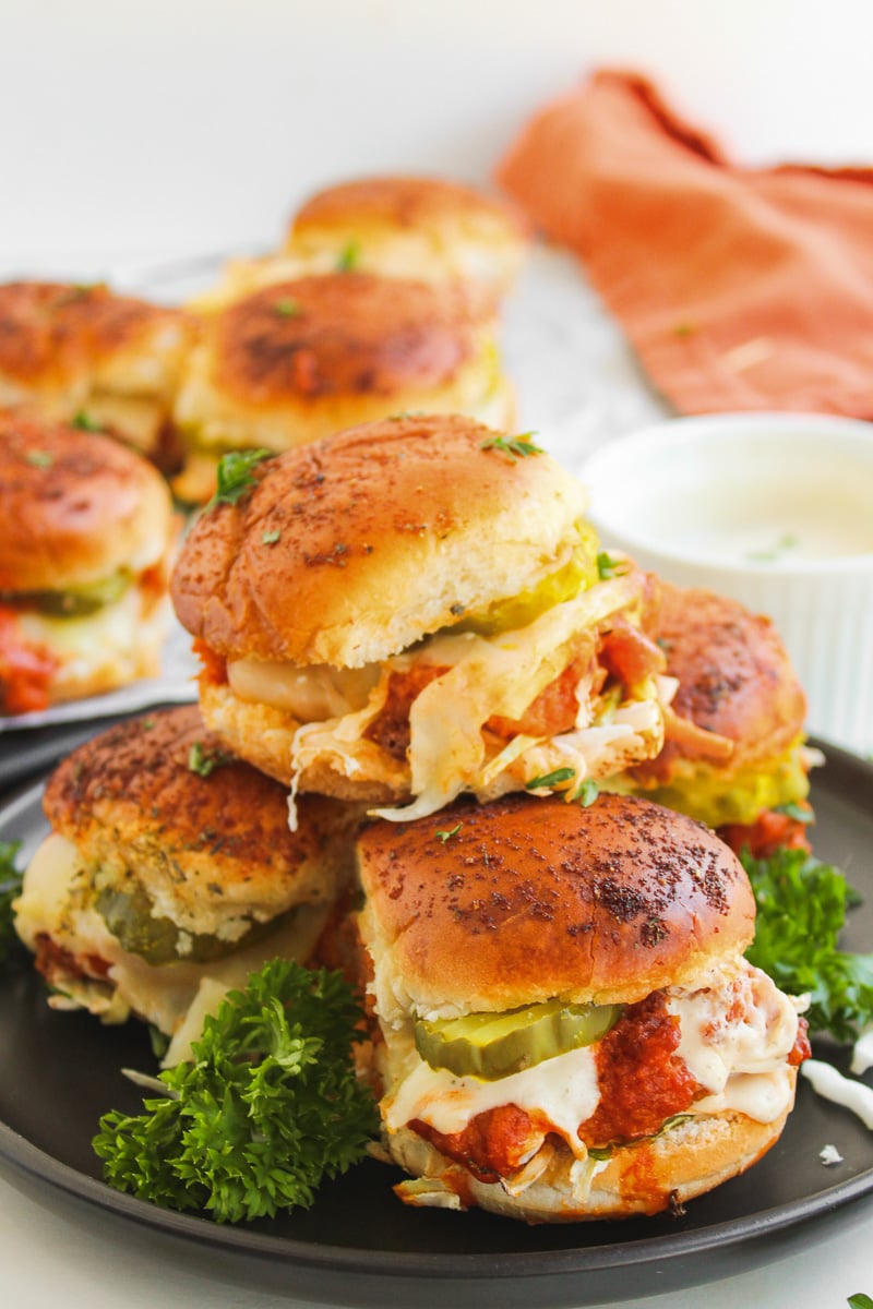 Buffalo chicken sliders on a plate.