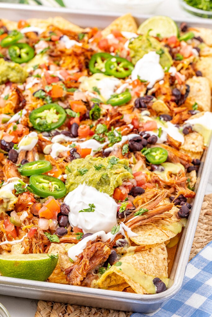 Pulled pork nachos on baking sheet.