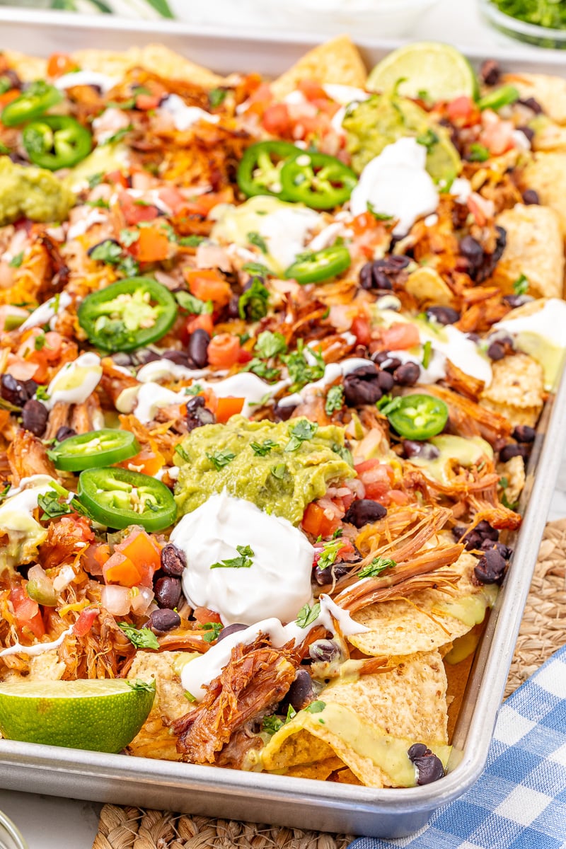 Pulled pork nachos on baking sheet.