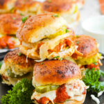 Buffalo chicken sliders served on a plate.