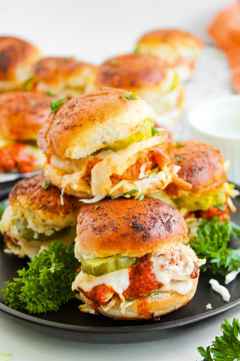Buffalo chicken sliders served on a plate.