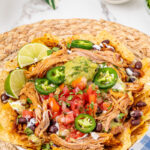 Pulled pork nachos on plate.