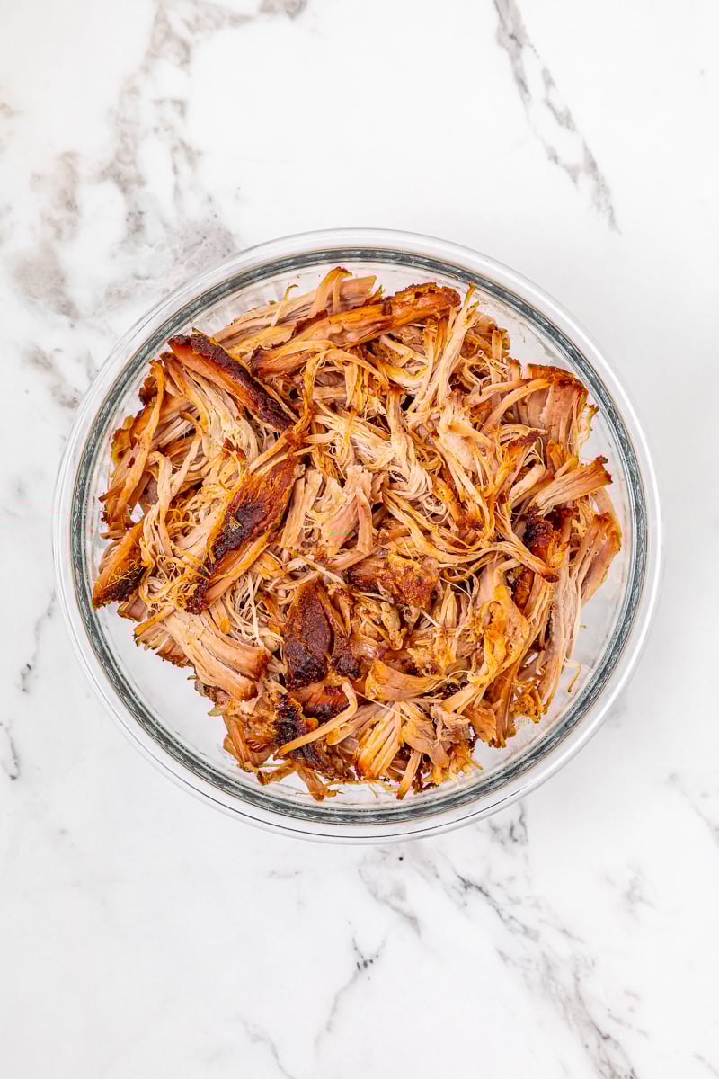 Reheated pull pork in glass bowl.